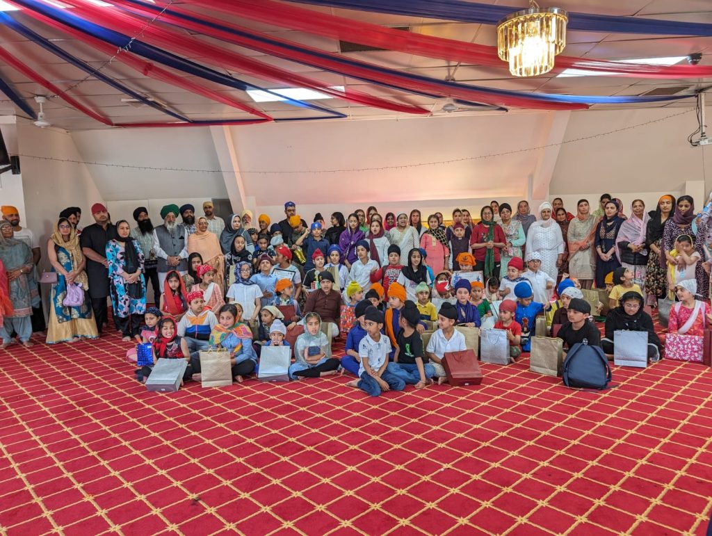 The ISSNZ sangat and children together at a community programme