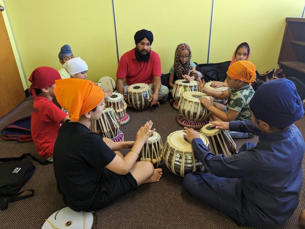 Young students learning tabla at the Institute